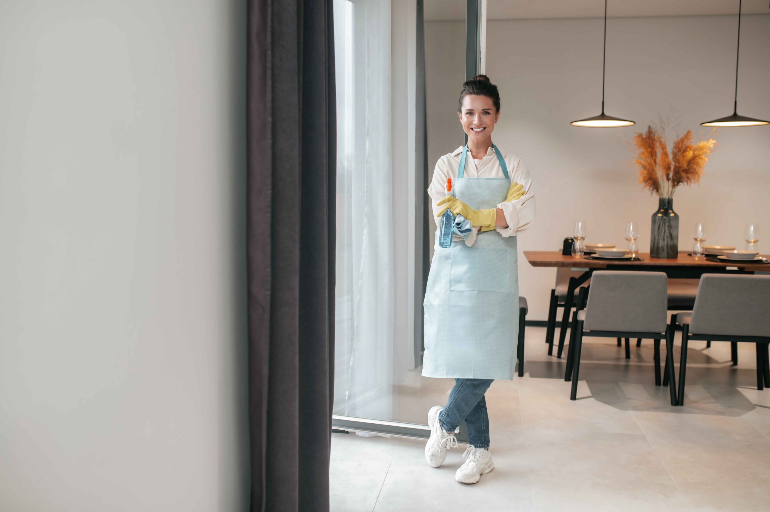 domestic-routine-smiling-housewife-apron-standing-kitchen