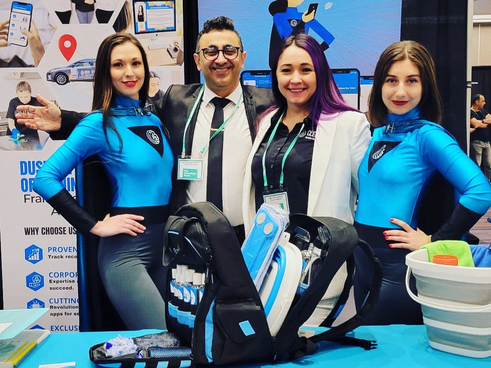 Cleany co-founders Olga Sokol and Shah Moghaddam with the Cleany team at a franchise expo